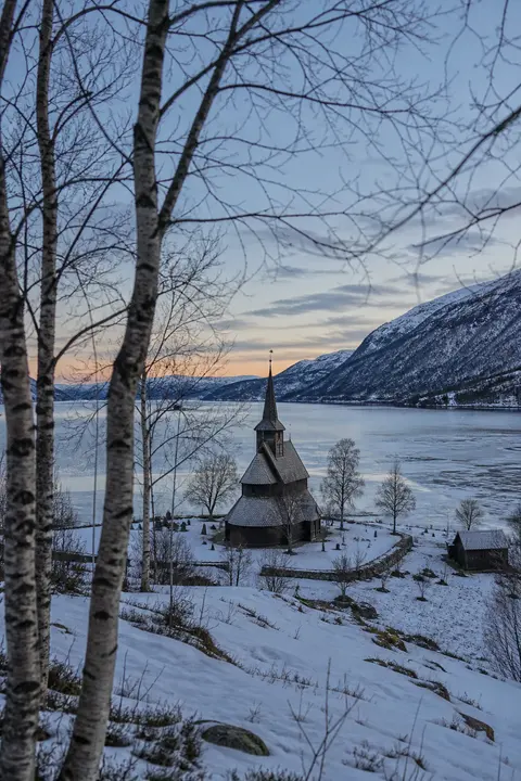 Snowy Nordic Church Beneath the Mountains