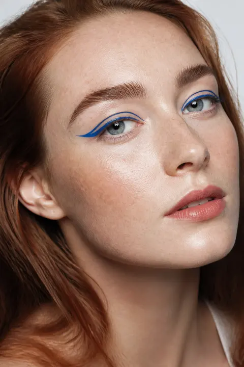 Fair Freckled Skin with Graphic Cobalt Eyeliner