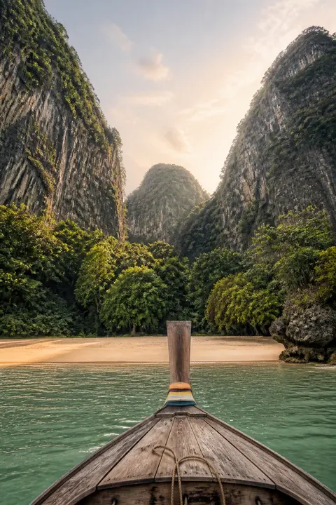 Longtail Boat Approaching a Jungle Cove