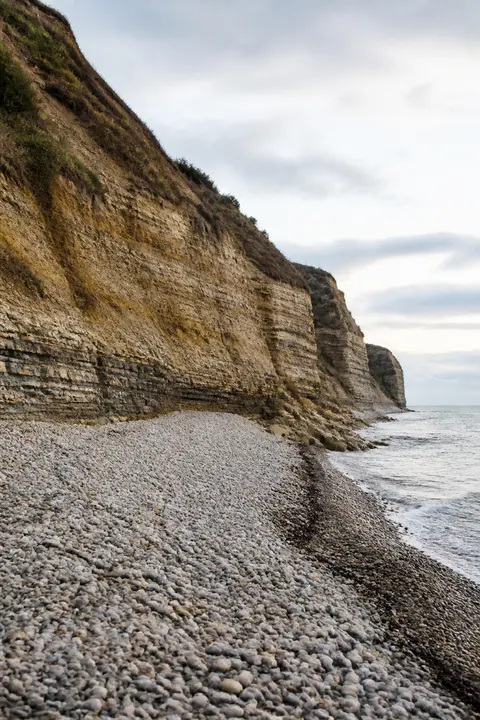 Layered Limestone Beach with White Pebbles
