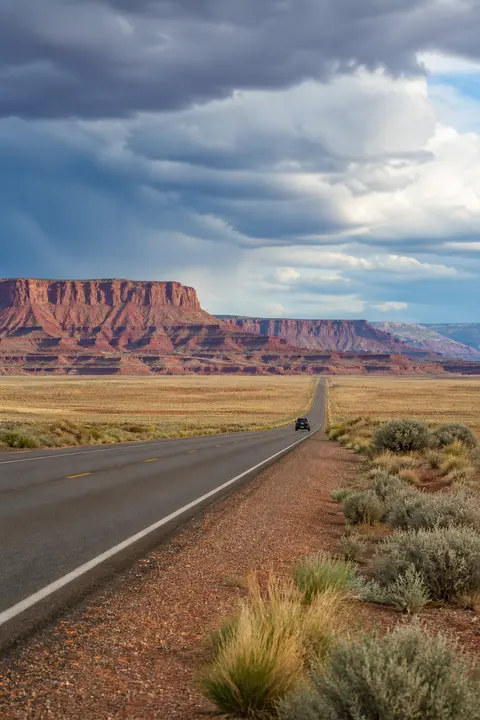 Open Desert Highway Beneath Storm Clouds