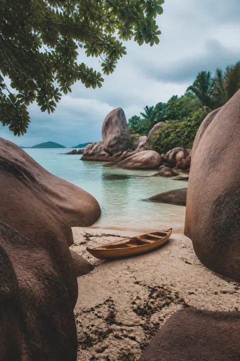 Granite Boulder Beach with Wooden Canoe