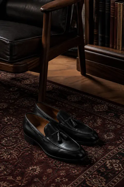 Black Leather Tassel Loafers in a Library